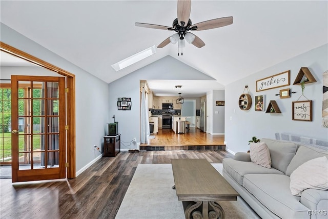 8005 Fir Dr, Clay, NY 13041 - living room with dark wood-style flooring, ceiling fan, vaulted ceiling, a skylight, and baseboards