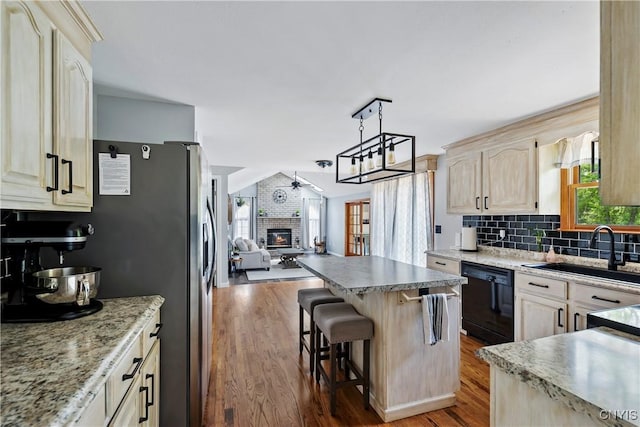 8005 Fir Dr, Clay, NY 13041 - kitchen featuring black dishwasher, a sink, open floor plan, light brown cabinetry, and wood finished floors