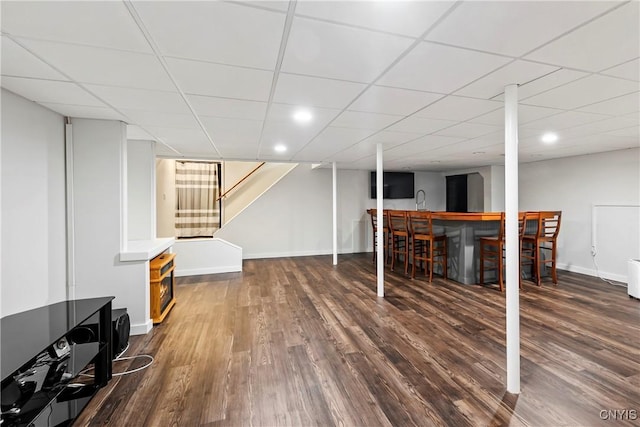 8005 Fir Dr, Clay, NY 13041 - finished basement with dark wood-style flooring, baseboards, a paneled ceiling, stairs, and recessed lighting