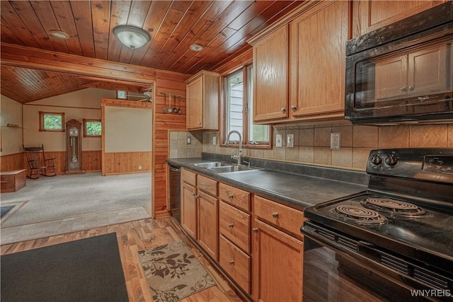 3557 Hartland Rd, Hartland, NY 14067 - kitchen with black appliances, a sink, wood walls, light wood-style flooring, and lofted ceiling