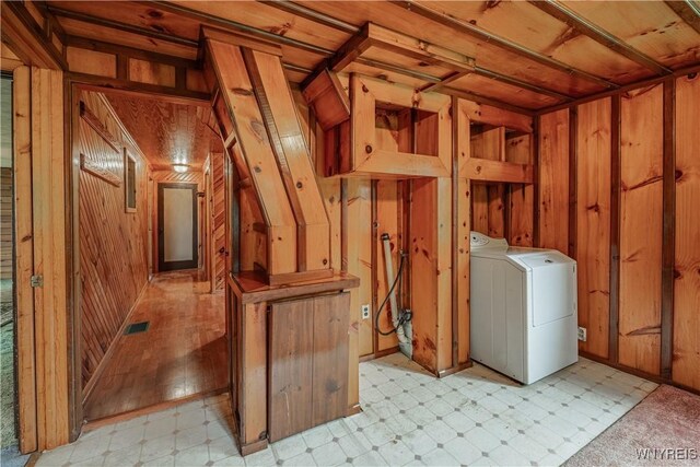 3557 Hartland Rd, Hartland, NY 14067 - below grade area featuring washer / clothes dryer, light floors, and wooden walls
