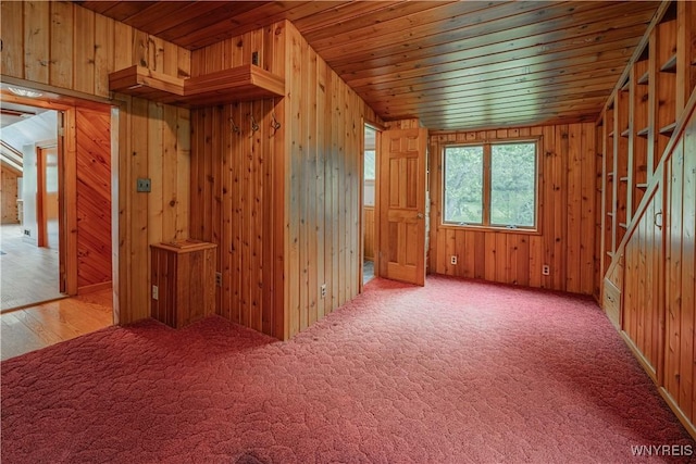 3557 Hartland Rd, Hartland, NY 14067 - carpeted spare room with wooden ceiling, wood walls, and stairs