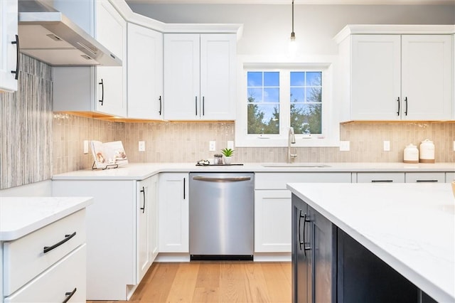 30 Legends Way, Greece, NY 14612 - kitchen featuring dishwasher, a sink, wall chimney exhaust hood, light wood finished floors, and decorative backsplash