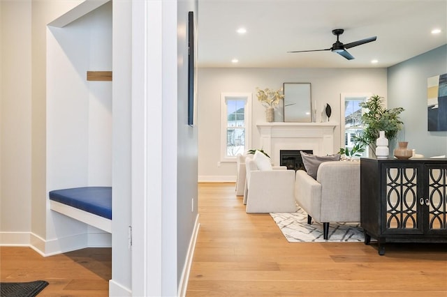 30 Legends Way, Greece, NY 14612 - living area featuring wood finished floors, a glass covered fireplace, ceiling fan, baseboards, and recessed lighting
