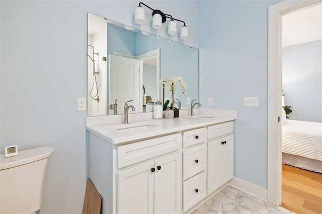 30 Legends Way, Greece, NY 14612 - full bathroom with double vanity, toilet, ensuite bath, marble finish flooring, and baseboards
