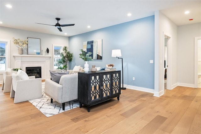 30 Legends Way, Greece, NY 14612 - living area featuring light wood-style floors, a ceiling fan, a glass covered fireplace, recessed lighting, and baseboards
