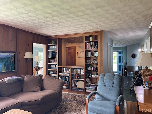 624 Deerfield Dr, Oneida-Inside, NY 13421 - living room with built in features, wood walls, wood finished floors, and a textured ceiling