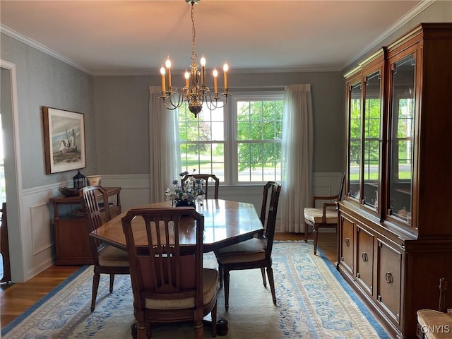 624 Deerfield Dr, Oneida-Inside, NY 13421 - dining room featuring light wood-type flooring, a chandelier, a wainscoted wall, ornamental molding, and a decorative wall