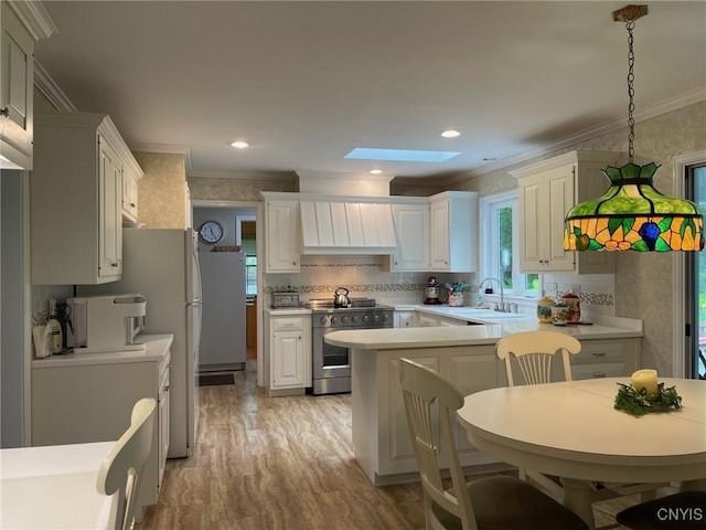 624 Deerfield Dr, Oneida-Inside, NY 13421 - kitchen with stainless steel stove, crown molding, a skylight, light countertops, and light wood-style flooring