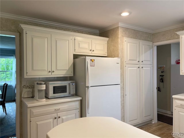 624 Deerfield Dr, Oneida-Inside, NY 13421 - kitchen with white appliances, white cabinetry, light countertops, crown molding, and wood finished floors