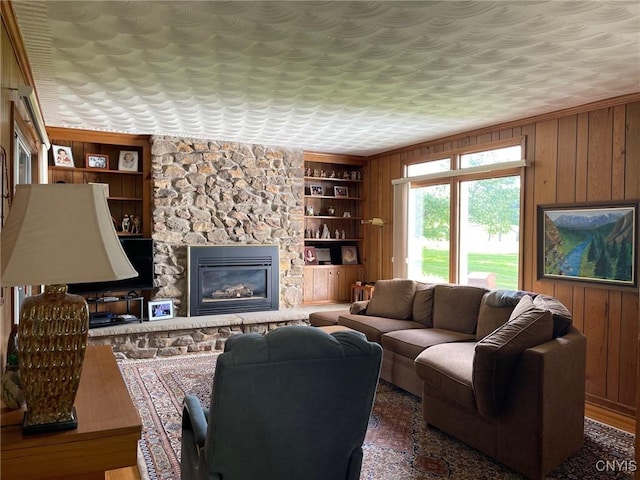 624 Deerfield Dr, Oneida-Inside, NY 13421 - living room with built in shelves, wood walls, and a fireplace