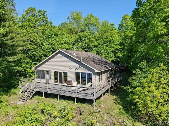 Hanson Bridge Road, Theresa, NY 13691 - back of house featuring a wooden deck, a view of trees, and roof with shingles