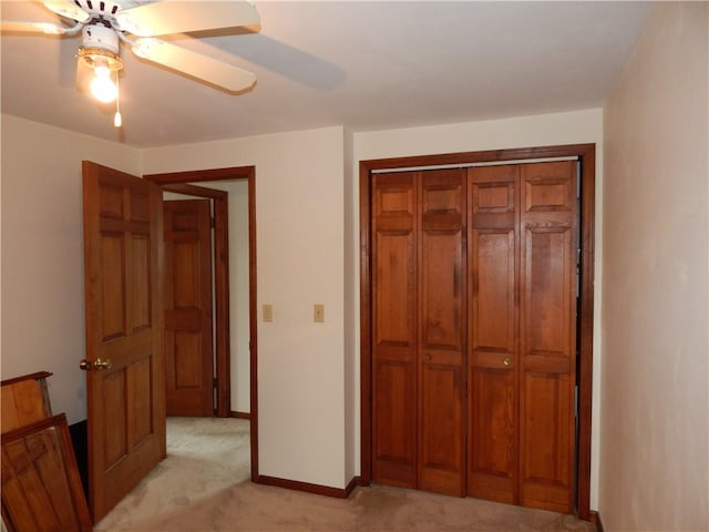 6731 Lake Salubria Dr, Bath, NY 14810 - unfurnished bedroom with light colored carpet, baseboards, a closet, and ceiling fan