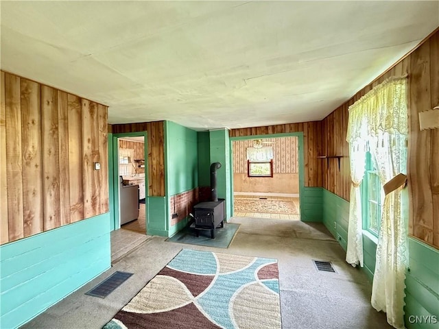 4151 State Route 20, Nelson, NY 13408 - miscellaneous room with wooden walls, carpet floors, a wood stove, and washer / dryer