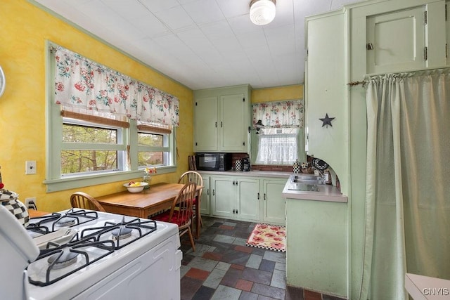 3435 E Lake Rd, Skaneateles, NY 13152 - kitchen featuring black microwave, plenty of natural light, white gas stove, and stone tile flooring