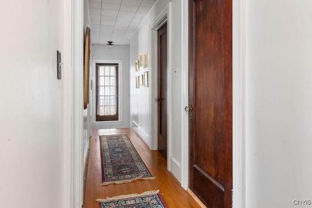 3435 E Lake Rd, Skaneateles, NY 13152 - corridor with wood finished floors, a drop ceiling, and baseboards