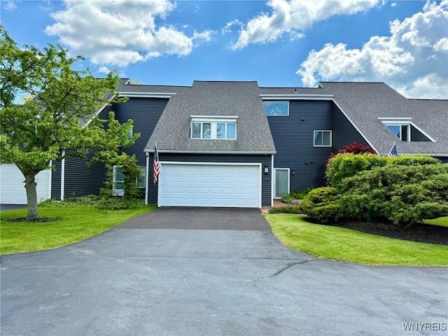 3134 E River Rd, Grand Island, NY 14072 - view of front facade with driveway, roof with shingles, a front lawn, and a garage