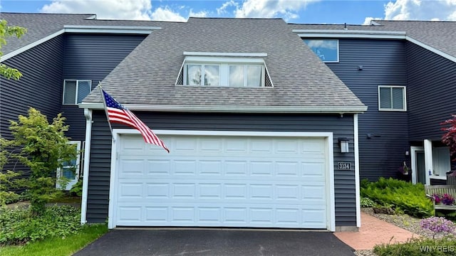3134 E River Rd, Grand Island, NY 14072 - view of side of property with roof with shingles, asphalt driveway, and an attached garage