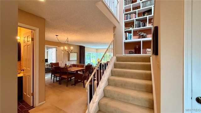 3134 E River Rd, Grand Island, NY 14072 - stairs with a chandelier, carpet floors, and a textured ceiling