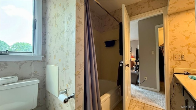 3134 E River Rd, Grand Island, NY 14072 - bathroom featuring shower / bath combination with curtain, vanity, toilet, tile patterned flooring, and wallpapered walls