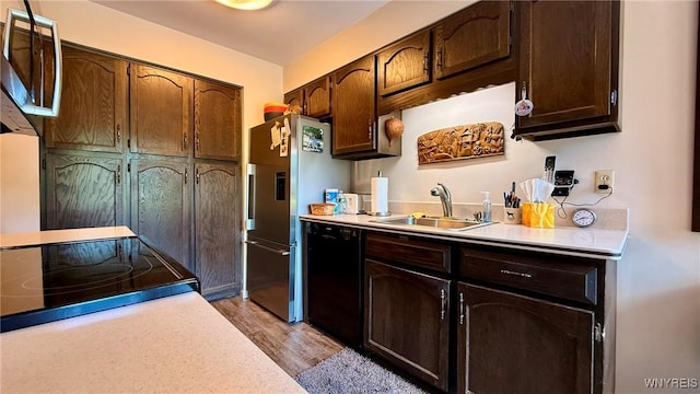 3134 E River Rd, Grand Island, NY 14072 - kitchen with stainless steel appliances, light countertops, a sink, light wood-style flooring, and dark brown cabinetry