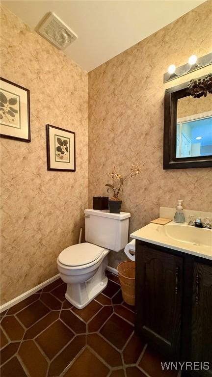 3134 E River Rd, Grand Island, NY 14072 - half bathroom featuring toilet, vanity, and baseboards