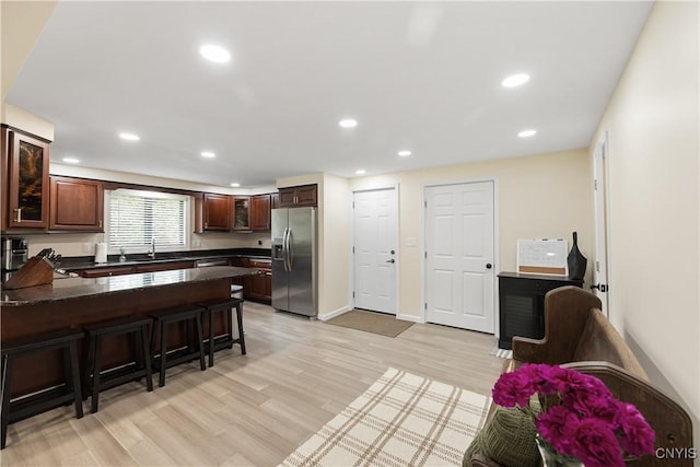 147 Crooked Lake Rd, Tully, NY 13159 - kitchen featuring stainless steel fridge with ice dispenser, a peninsula, a breakfast bar area, recessed lighting, and light wood finished floors
