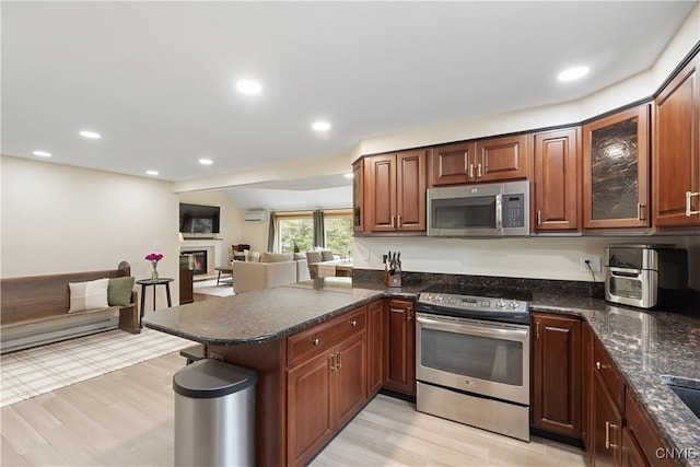 147 Crooked Lake Rd, Tully, NY 13159 - kitchen featuring stainless steel appliances, a peninsula, open floor plan, light wood-style floors, and recessed lighting