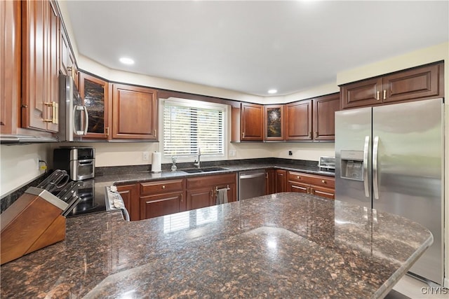 147 Crooked Lake Rd, Tully, NY 13159 - kitchen with stainless steel appliances, glass insert cabinets, recessed lighting, a peninsula, and dark stone countertops