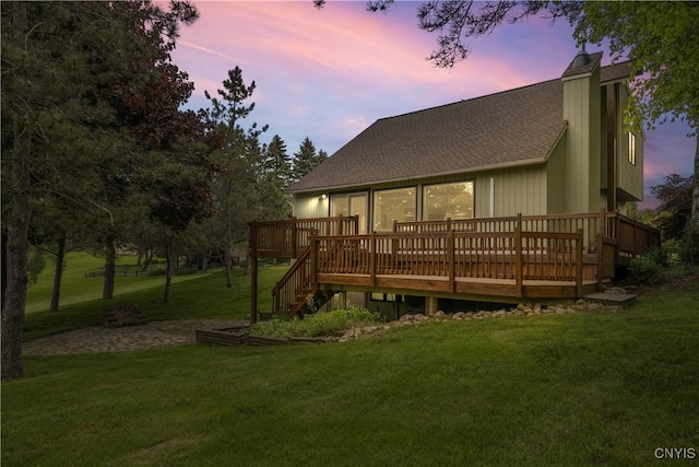 147 Crooked Lake Rd, Tully, NY 13159 - back of house at dusk with a shingled roof, a wooden deck, a lawn, and stairway