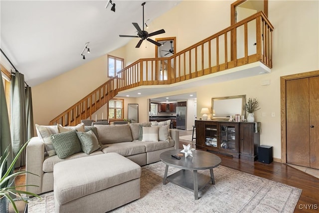 147 Crooked Lake Rd, Tully, NY 13159 - living area featuring a ceiling fan, high vaulted ceiling, wood finished floors, stairway, and track lighting