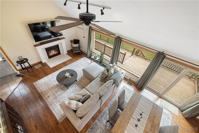 147 Crooked Lake Rd, Tully, NY 13159 - living area with ceiling fan, a fireplace with flush hearth, hardwood / wood-style flooring, and rail lighting