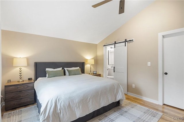 147 Crooked Lake Rd, Tully, NY 13159 - bedroom with a barn door, light wood-type flooring, lofted ceiling, ensuite bath, and a ceiling fan