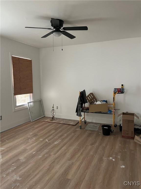 2608 Midland Ave, Syracuse, NY 13205 - spare room featuring wood finished floors, a ceiling fan, and baseboards