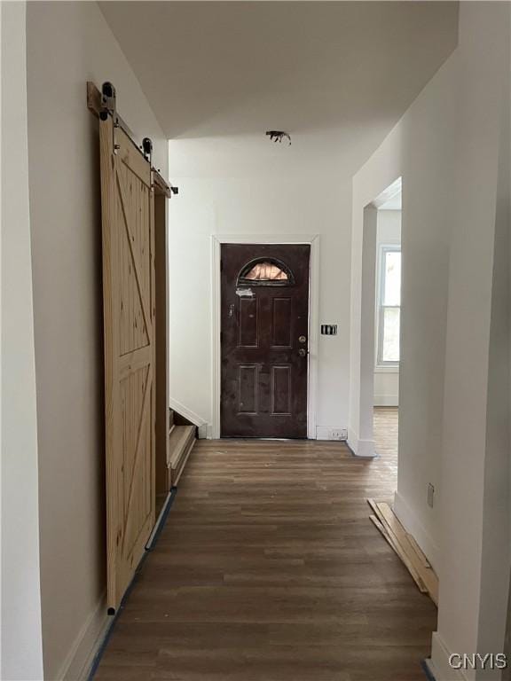 2608 Midland Ave, Syracuse, NY 13205 - hallway with wood finished floors, a barn door, and baseboards