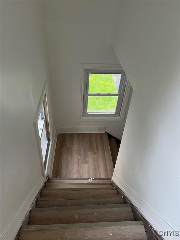 2608 Midland Ave, Syracuse, NY 13205 - staircase featuring wood finished floors and vaulted ceiling