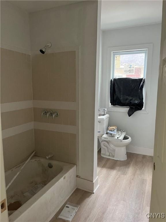 2608 Midland Ave, Syracuse, NY 13205 - full bathroom featuring wood finished floors, bathtub / shower combination, toilet, and baseboards