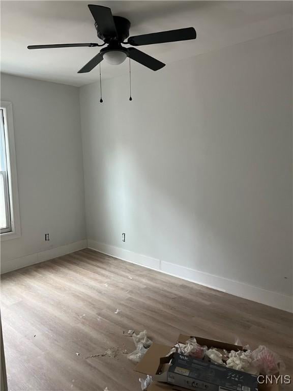 2608 Midland Ave, Syracuse, NY 13205 - unfurnished room with wood finished floors, baseboards, and a ceiling fan