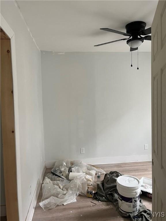 2608 Midland Ave, Syracuse, NY 13205 - unfurnished room featuring a ceiling fan, wood finished floors, and baseboards