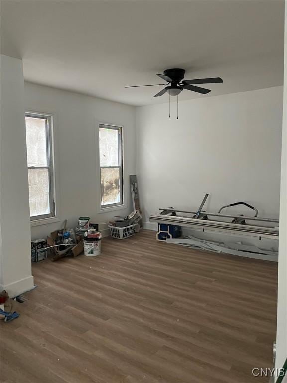 2608 Midland Ave, Syracuse, NY 13205 - empty room with wood finished floors, a ceiling fan, and baseboards