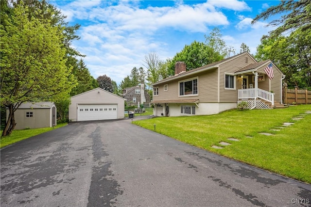 96 Lynbrook Cir, Dewitt, NY 13214 - view of front of house with an outbuilding, a detached garage, a chimney, and a front lawn