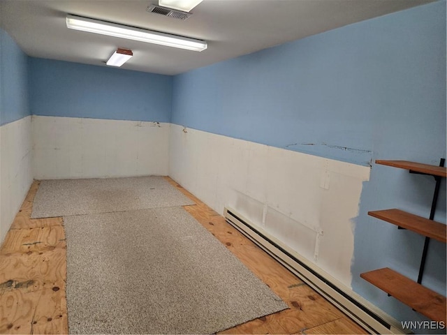 4003 Wood Rd, Albion, NY 14411 - empty room featuring a baseboard radiator and a wainscoted wall