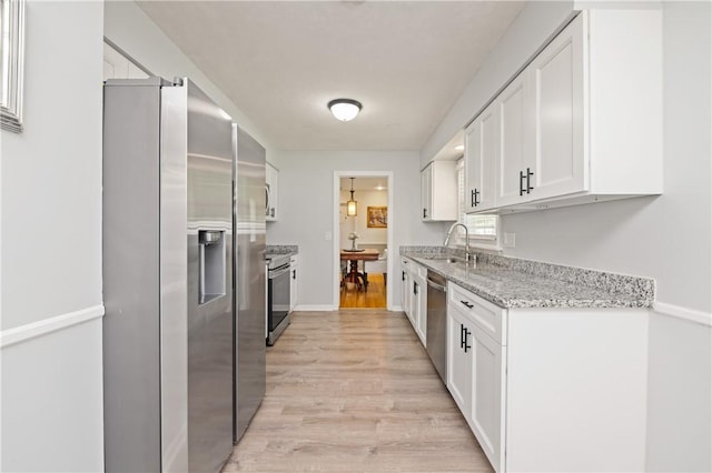 1 Briar Way, Perinton, NY 14450 - kitchen featuring stainless steel appliances, white cabinetry, light wood-style flooring, and light stone countertops