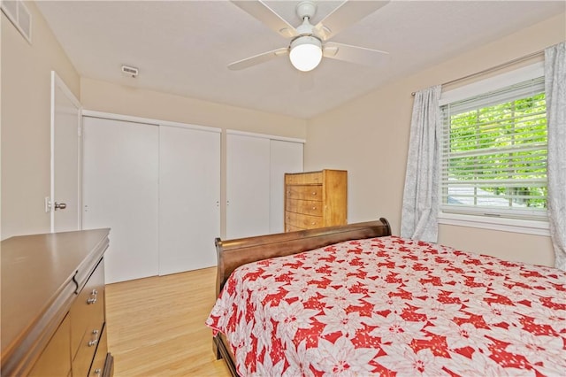1 Briar Way, Perinton, NY 14450 - bedroom featuring multiple closets, light wood-style floors, and ceiling fan