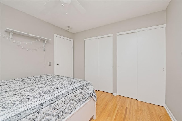 1 Briar Way, Perinton, NY 14450 - bedroom with two closets, light wood finished floors, and ceiling fan