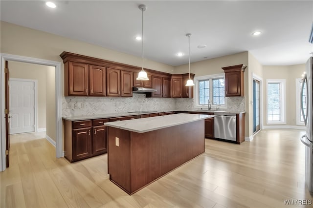 25 Davinci Ct, Amherst, NY 14221 - kitchen with stainless steel dishwasher, under cabinet range hood, decorative backsplash, a kitchen island, and a sink
