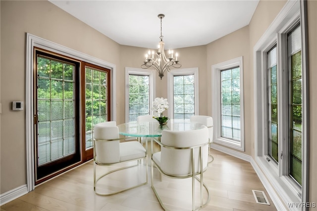 25 Davinci Ct, Amherst, NY 14221 - dining room with a chandelier, light wood-style flooring, and baseboards