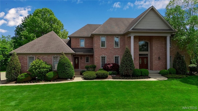 25 Davinci Ct, Amherst, NY 14221 - neoclassical home featuring a front yard, brick siding, and a shingled roof