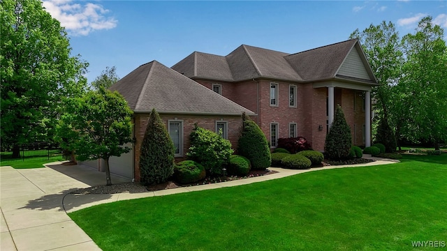 25 Davinci Ct, Amherst, NY 14221 - neoclassical home featuring a front yard, brick siding, driveway, and roof with shingles