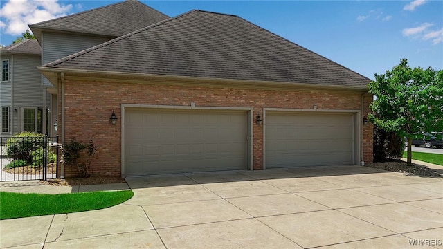 25 Davinci Ct, Amherst, NY 14221 - view of side of home featuring brick siding, concrete driveway, a garage, and roof with shingles